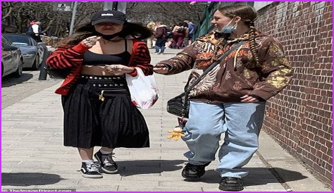 Olivia Rodrigo rocks a tiny black sports bra and an edgy pleated skirt during time out in Toronto